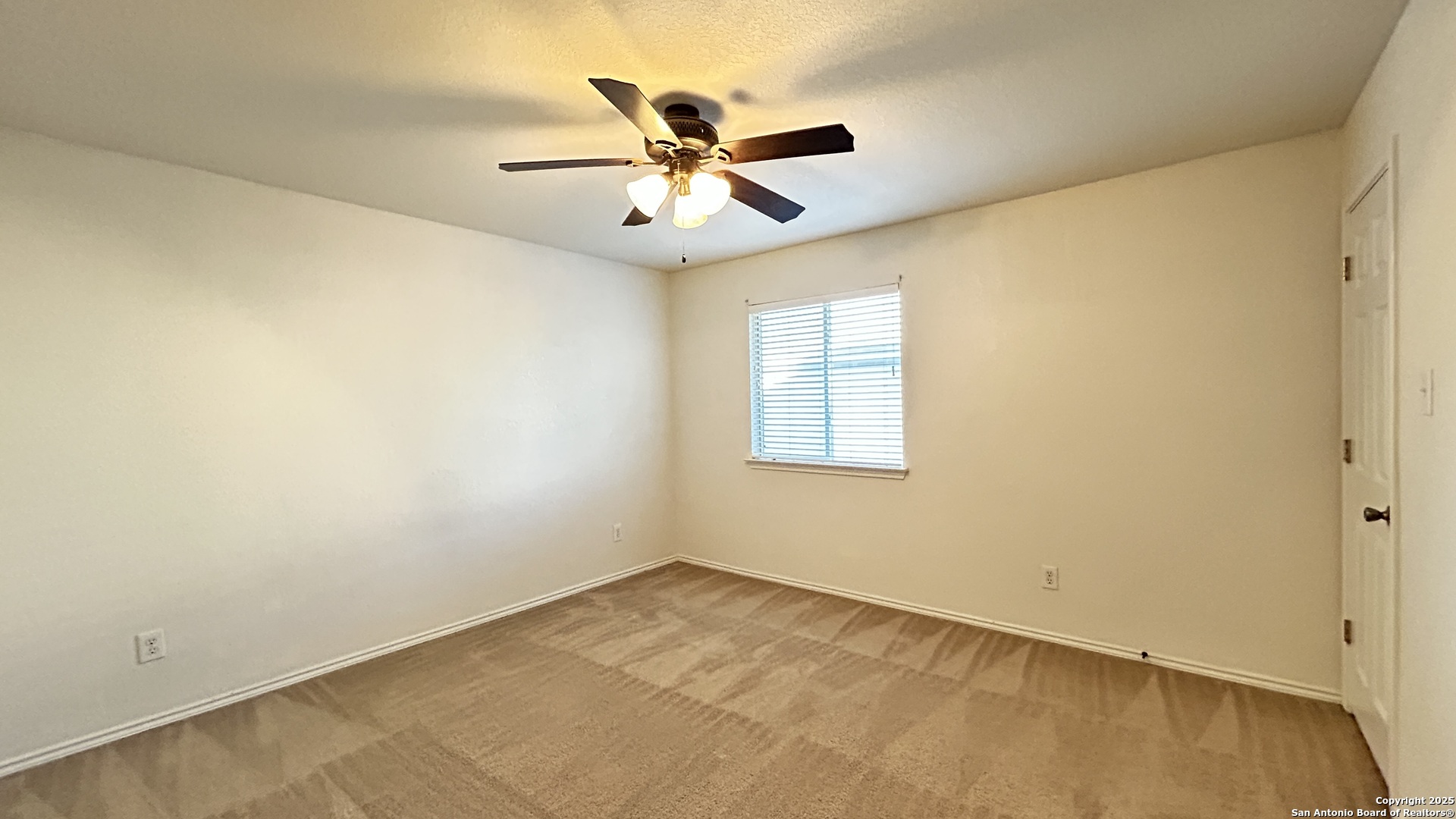11015 Mustang Spring San Antonio, TX 78254 - Photo 19 of 29 an empty room with window and ceiling fan