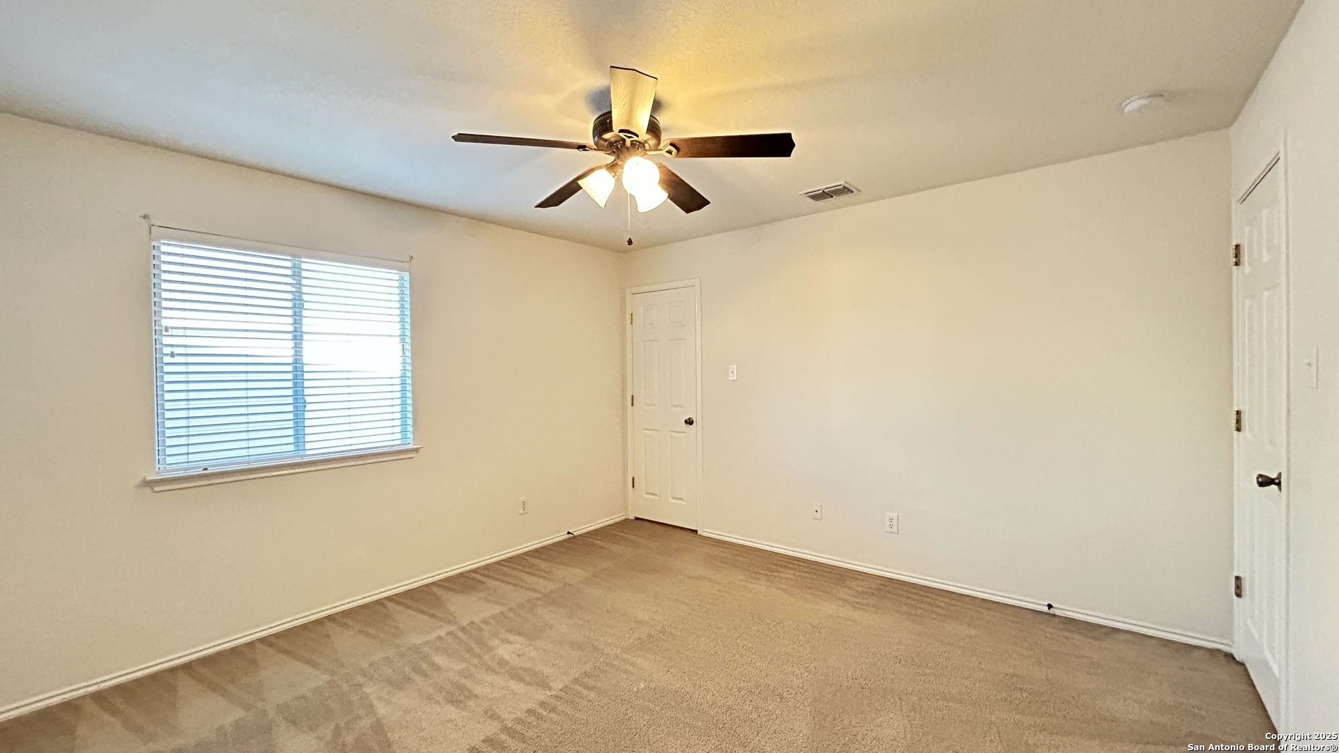 11015 Mustang Spring San Antonio, TX 78254 - Photo 20 of 29 an empty room with windows and fan