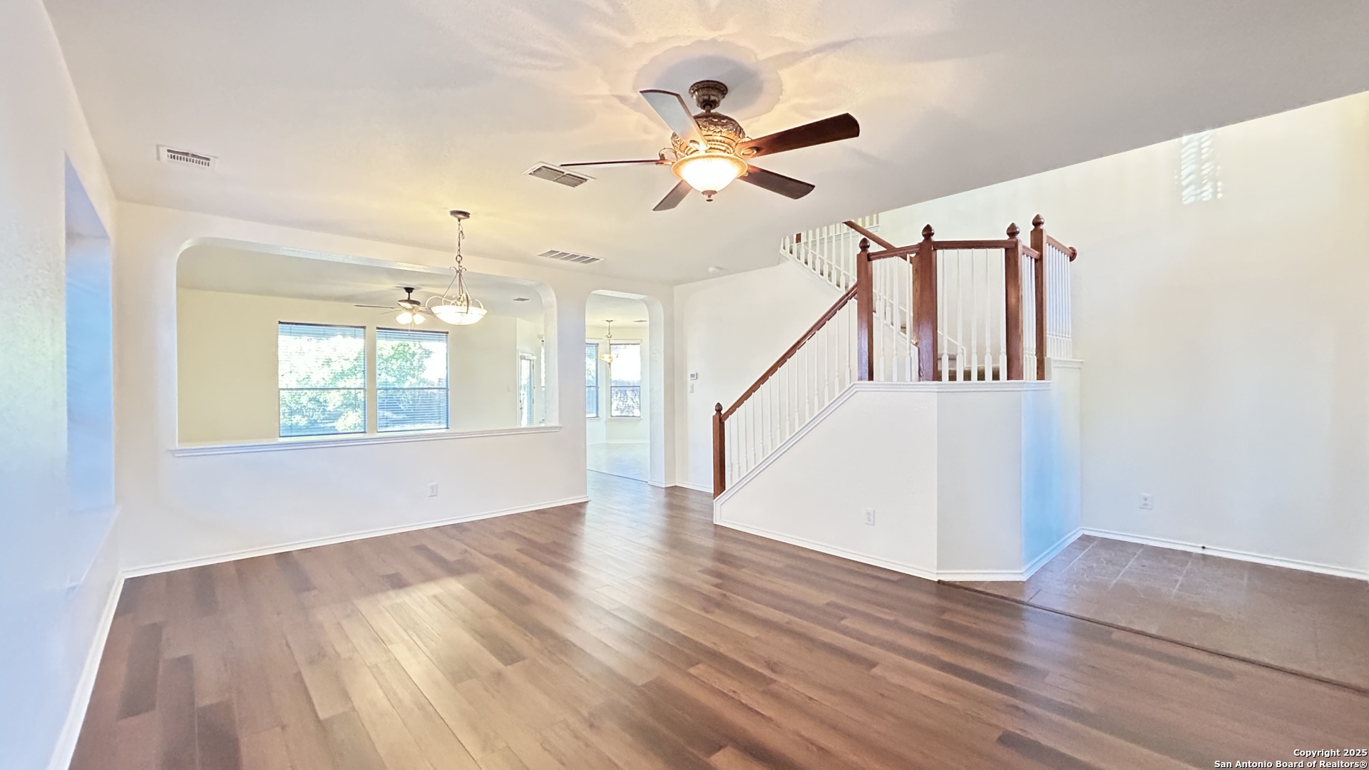 11015 Mustang Spring San Antonio, TX 78254 - Photo 2 of 29 a view of an entryway with wooden floor and a ceiling fan