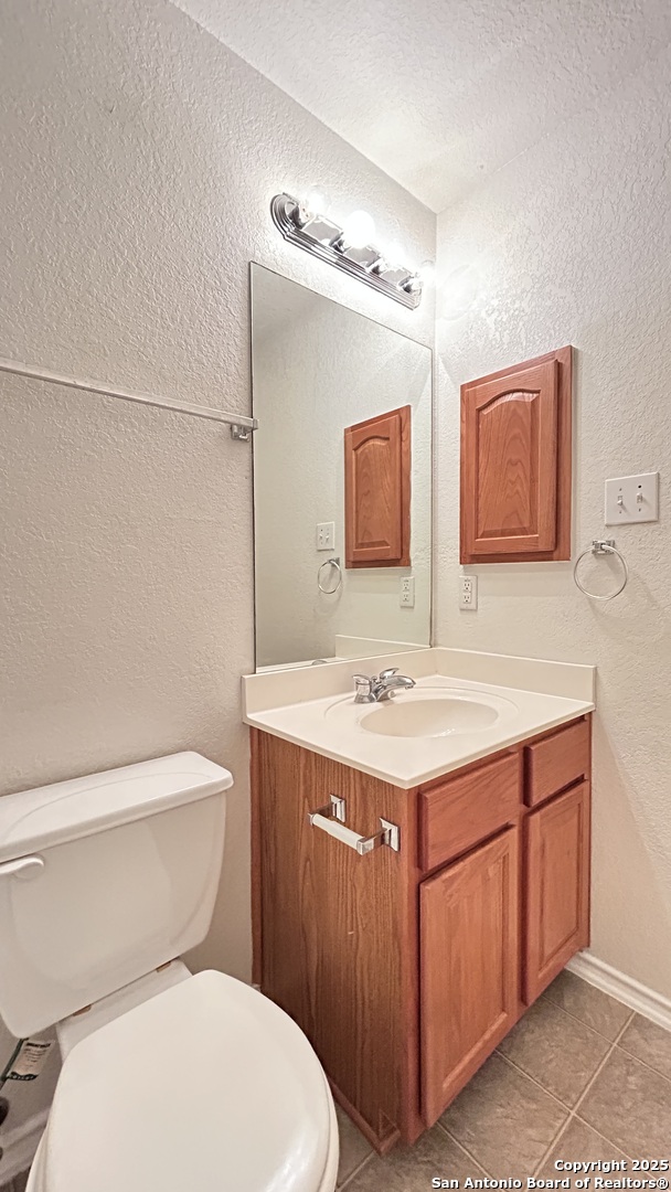 11015 Mustang Spring San Antonio, TX 78254 - Photo 22 of 29 a bathroom with a sink a toilet a mirror and shower