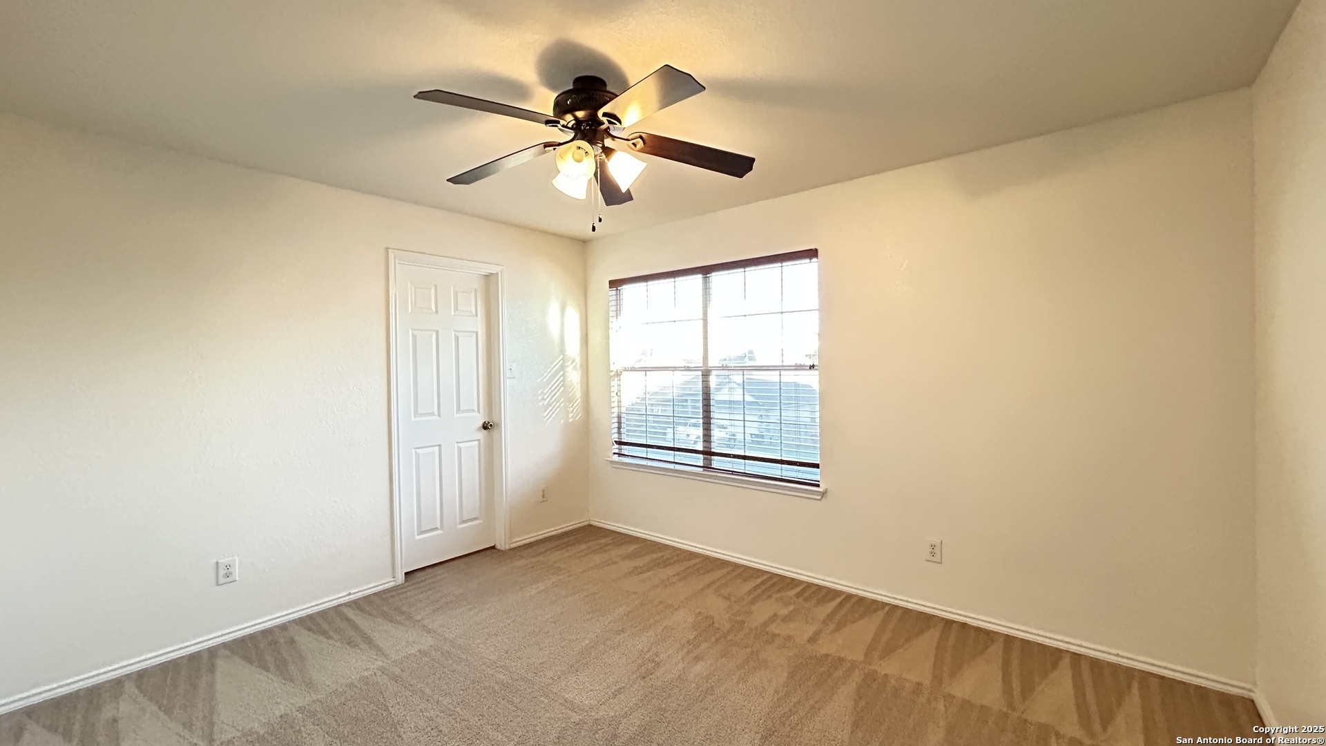 11015 Mustang Spring San Antonio, TX 78254 - Photo 24 of 29 an empty room with windows and fan