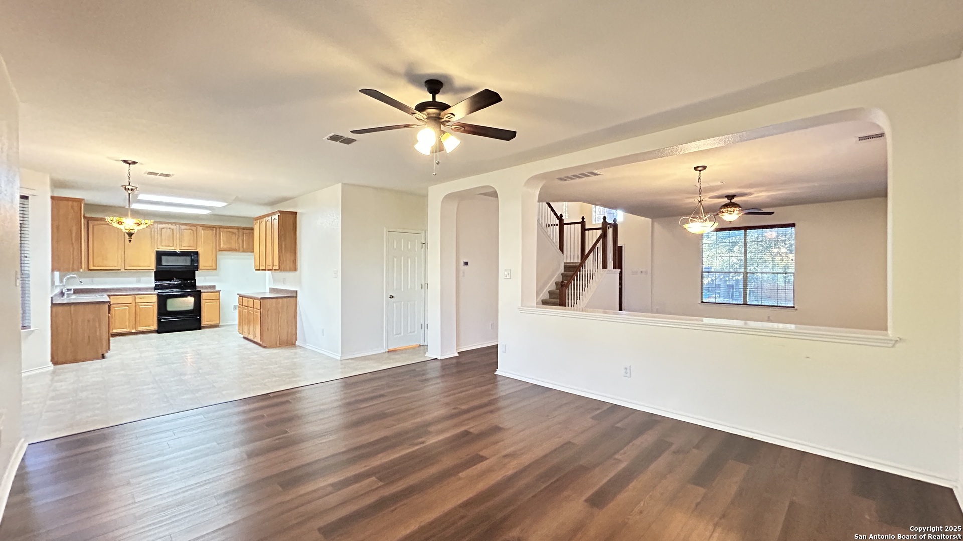 11015 Mustang Spring San Antonio, TX 78254 - Photo 4 of 29 a view of a living room and kitchen with wooden floor