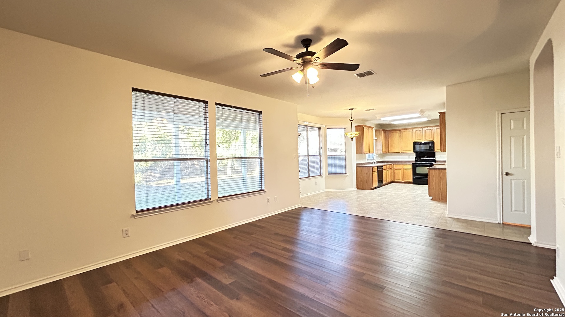11015 Mustang Spring San Antonio, TX 78254 - Photo 5 of 29 a view of empty room with wooden floor and fan