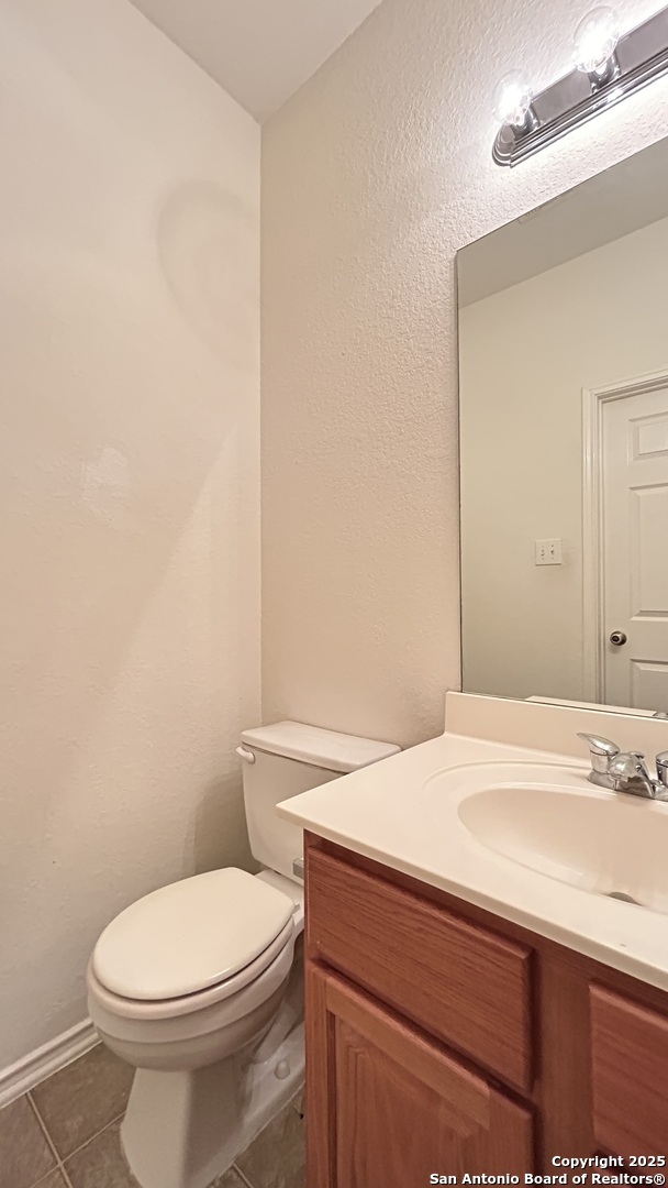 11015 Mustang Spring San Antonio, TX 78254 - Photo 10 of 29 a bathroom with a sink a toilet and mirror