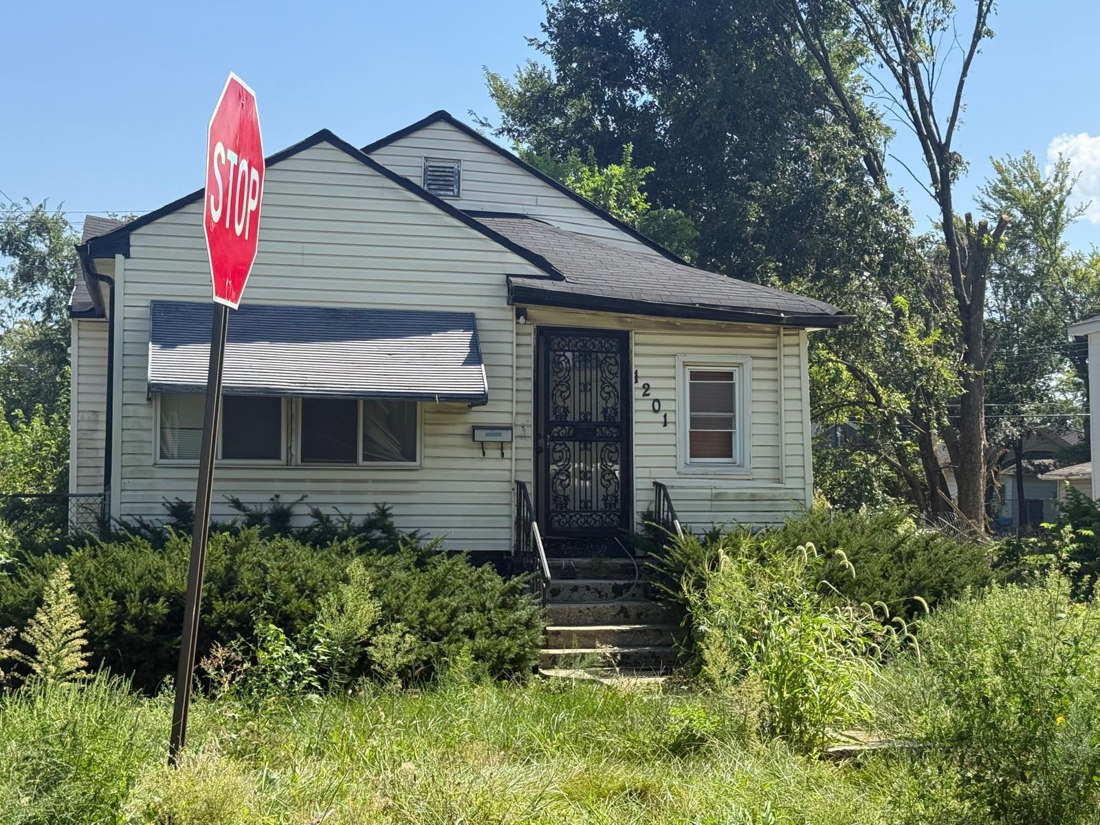 1201 Rutledge Street Gary, IN 46404 - Photo 4 of 6 a view of a house with brick walls and potted plants