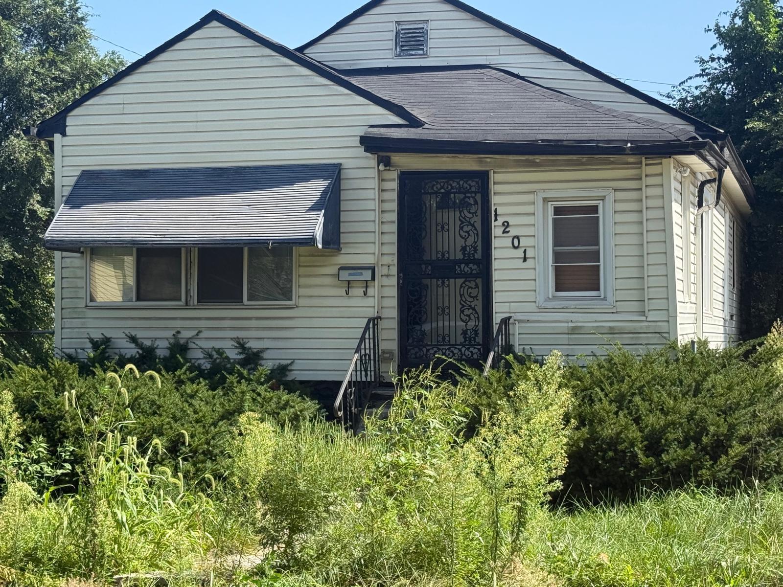 1201 Rutledge Street Gary, IN 46404 - Photo 5 of 6 a front view of a house with a yard