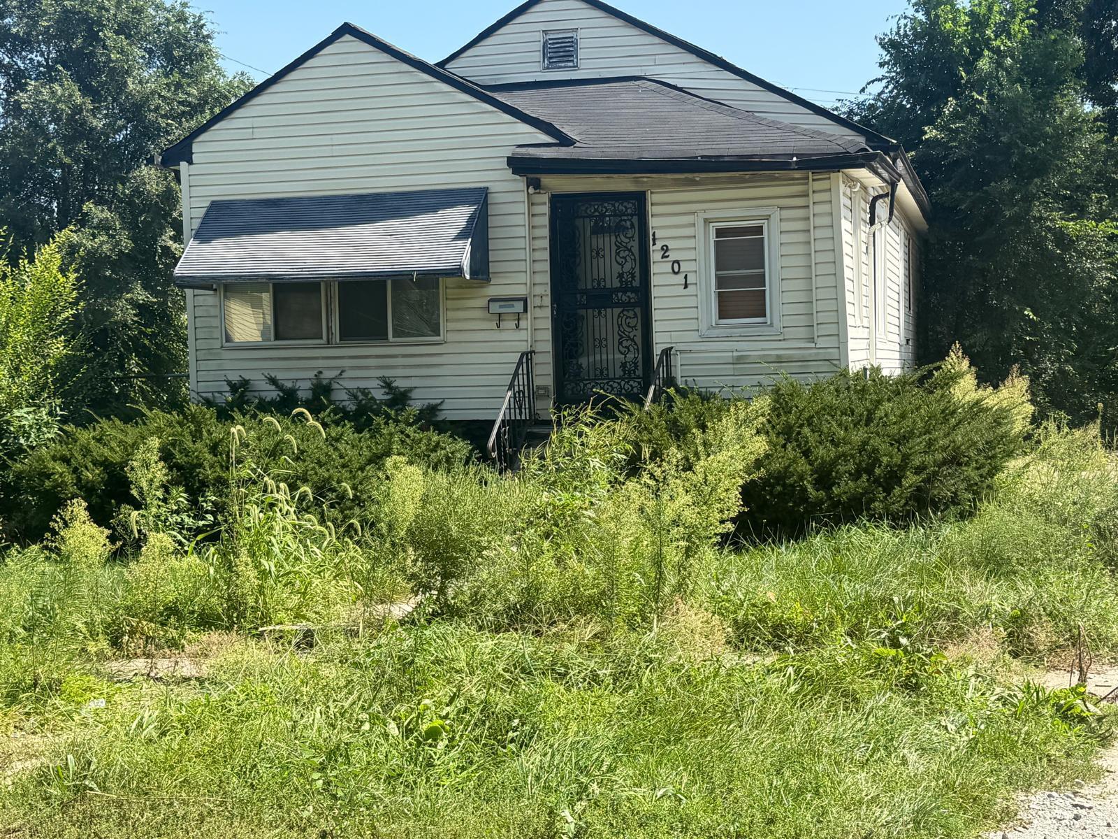1201 Rutledge Street Gary, IN 46404 - Photo 6 of 6 a front view of a house with a garden