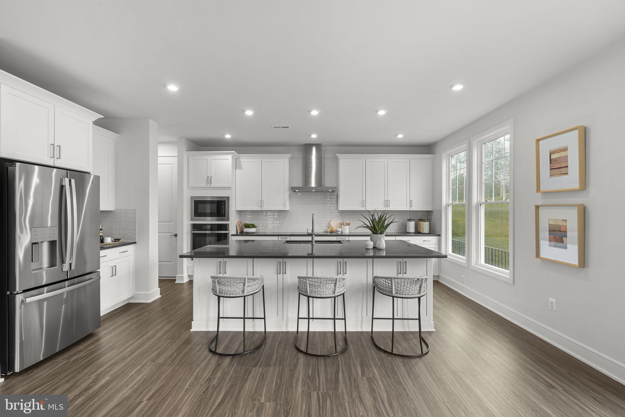 2611 Blue Rdg Avenue Marshall, VA 20115 - Photo 15 of 47 a white kitchen with wooden floors and stainless steel appliances