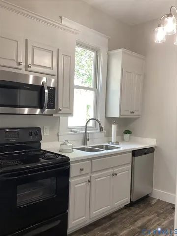 a kitchen with a sink stove and microwave
