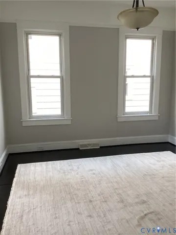 a view of entryway with window and wooden floor