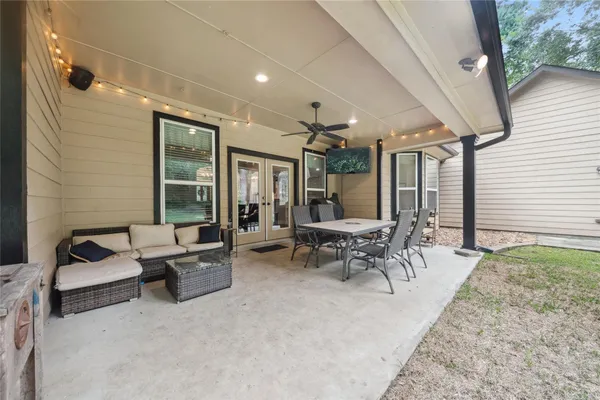 a patio with patio couch and outdoor seating