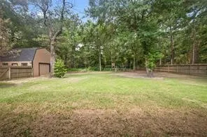 a backyard of a house with lots of green space and fountain