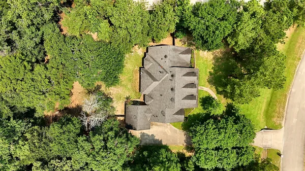 an aerial view of a house with a yard