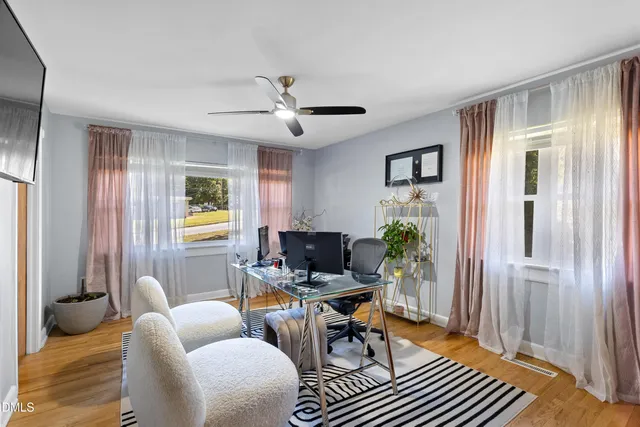 a living room with furniture a ceiling fan and a window
