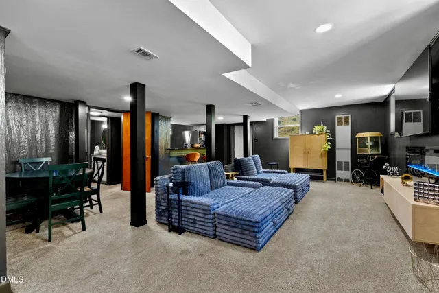 a living room with furniture and dining area