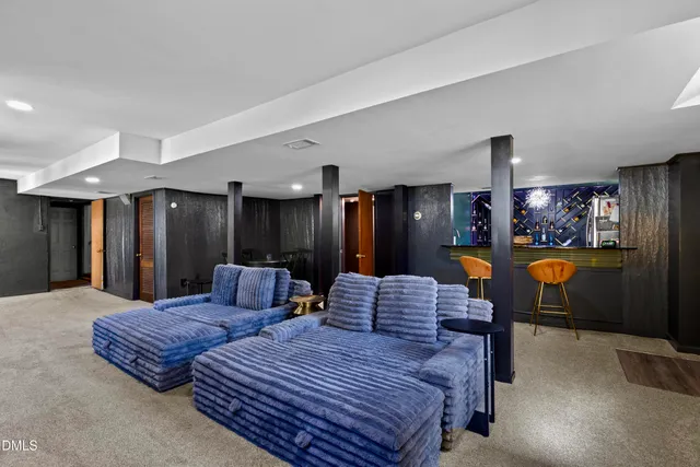 a spacious bedroom with a bed and glass tables