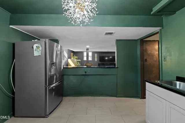 a view of kitchen with a refrigerator and microwave