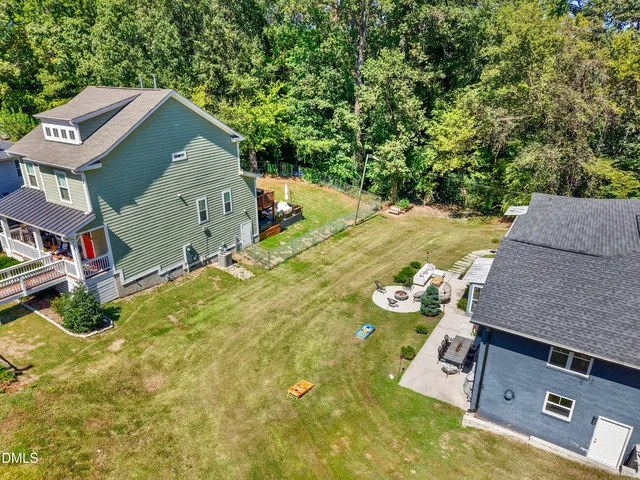 an aerial view of a house with swimming pool and patio