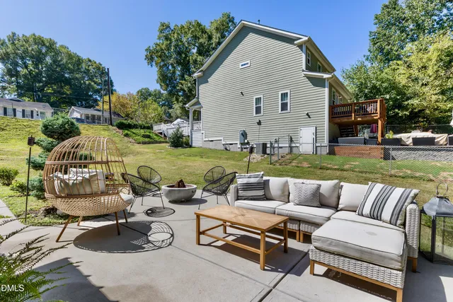 a view of a backyard with swimming pool and furniture