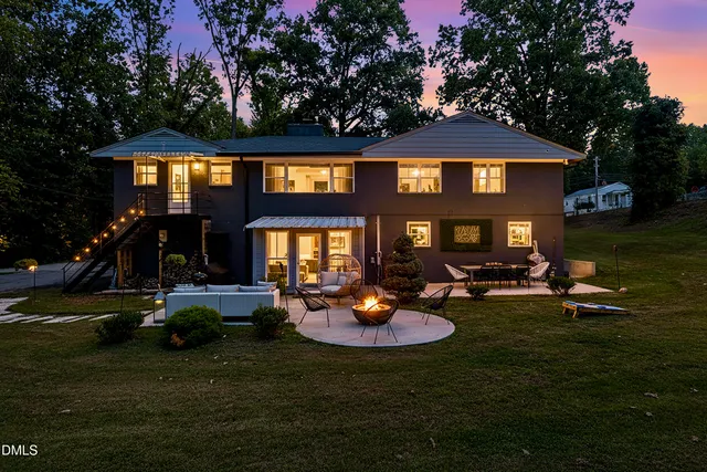 a view of a house with backyard porch and sitting area