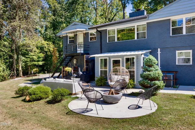 a view of a house with backyard sitting area and swimming pool