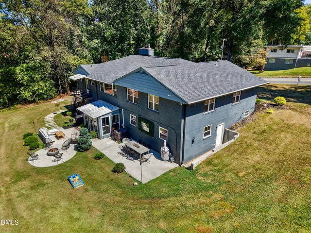 a backyard of a house with table and chairs