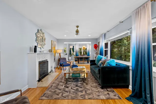 a living room with fireplace furniture and a fireplace