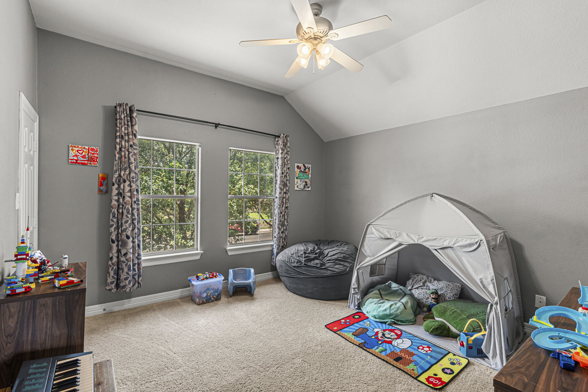454 Fall Circle Kyle, TX 78640 - Photo 29 of 39 A children's room offers ample natural illumination and vaulted ceilings for an airy feel.