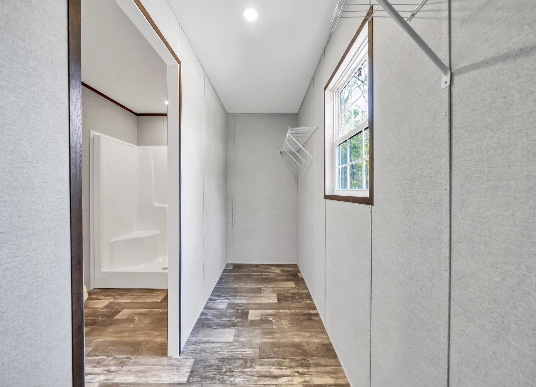 163 Gregory Dean Lane DeFuniak Springs, FL 32433 - Photo 21 of 24 a view of a hallway with wooden floor and staircase