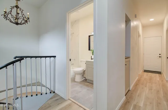 a view of a hallway with a door and wooden floor