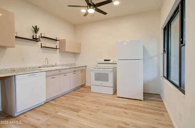 a kitchen with white cabinets and white appliances
