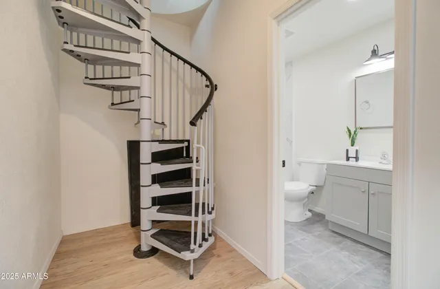 a view of a hallway with wooden floor and workspace