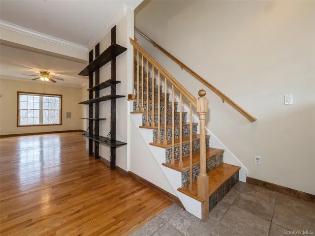 a view of entryway with wooden floor and stairs