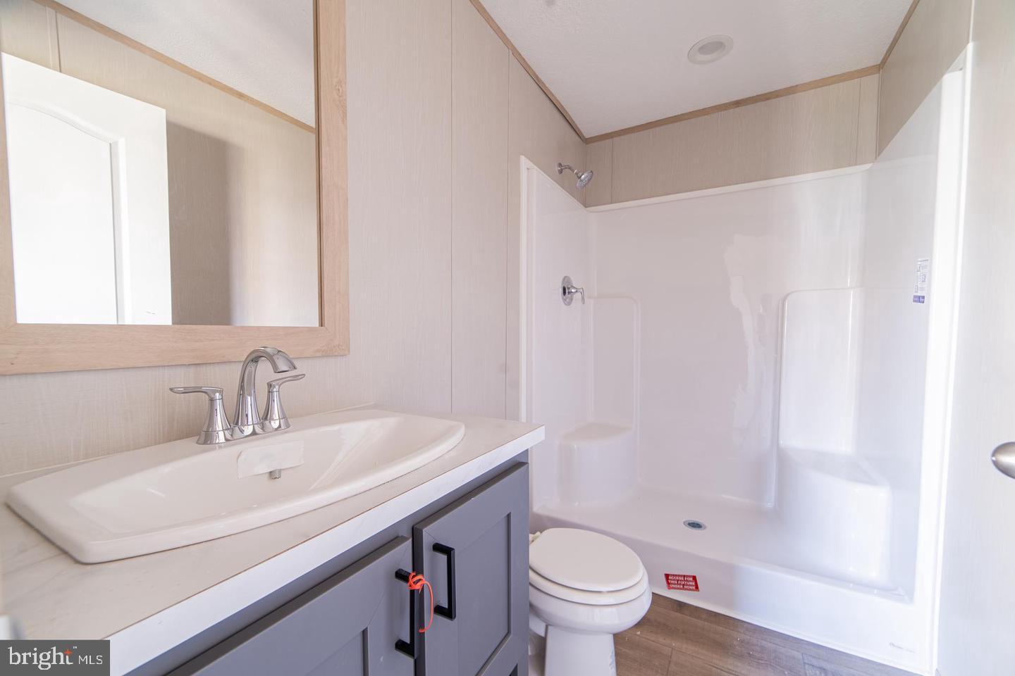 450 Clarks Pond Road, Unit 36 Bridgeton, NJ 08302 - Photo 4 of 4 a bathroom with a sink a toilet and a mirror