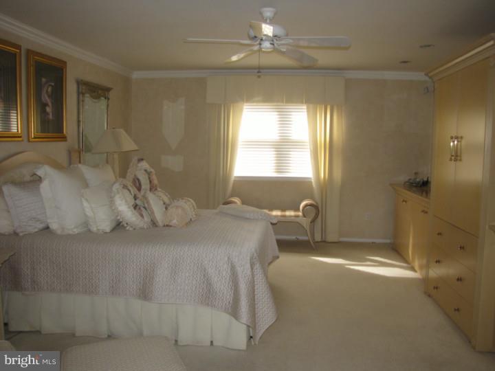 217 Sandringham Road Cherry Hill, NJ 08003 - Photo 14 of 25 a spacious bedroom with a bed and a window
