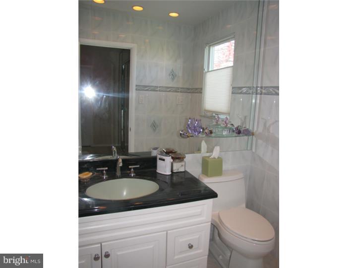 217 Sandringham Road Cherry Hill, NJ 08003 - Photo 15 of 25 a bathroom with a granite countertop sink toilet and mirror