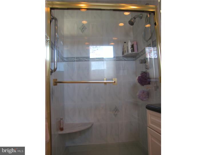 217 Sandringham Road Cherry Hill, NJ 08003 - Photo 16 of 25 a bathroom with a glass shower door