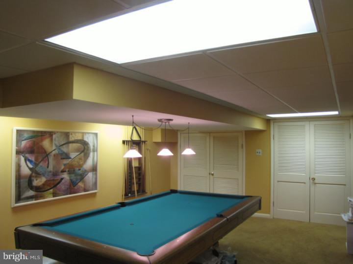 217 Sandringham Road Cherry Hill, NJ 08003 - Photo 22 of 25 a room with pool table and paintings on the wall