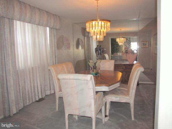 217 Sandringham Road Cherry Hill, NJ 08003 - Photo 5 of 25 a dining room with furniture a chandelier and window