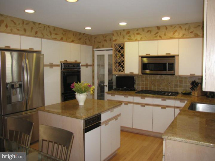 217 Sandringham Road Cherry Hill, NJ 08003 - Photo 6 of 25 a kitchen with a refrigerator a oven and a sink