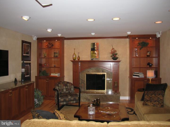 217 Sandringham Road Cherry Hill, NJ 08003 - Photo 10 of 25 a living room with furniture a flat screen tv and a fireplace