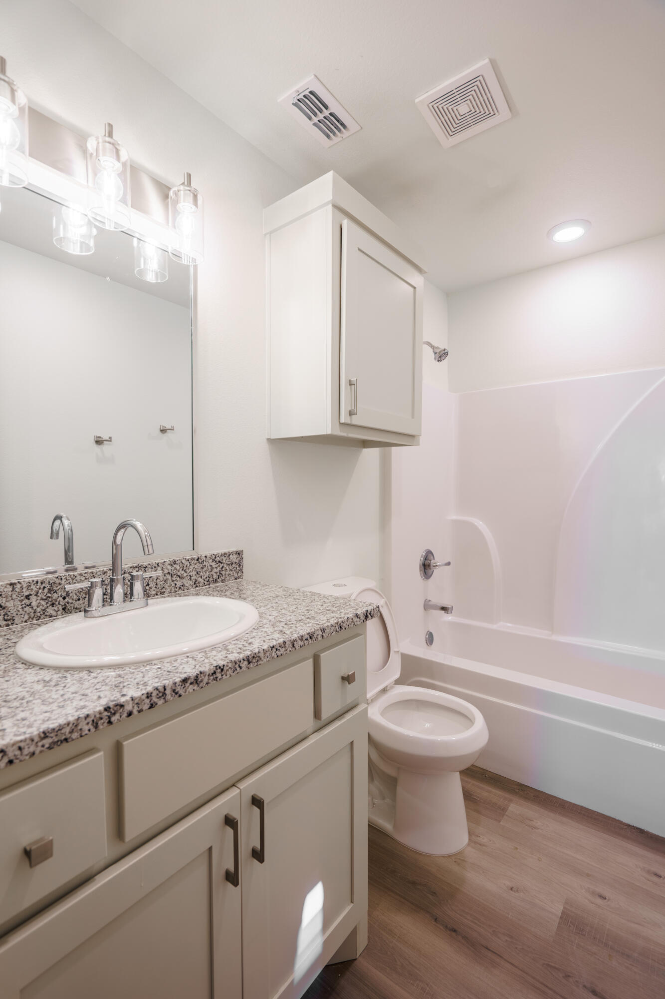 8023 Date Avenue Lubbock, TX 79404 - Photo 5 of 14 a bathroom with a granite countertop toilet sink and mirror