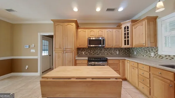 a spacious bathroom with a double vanity sink a mirror and a
