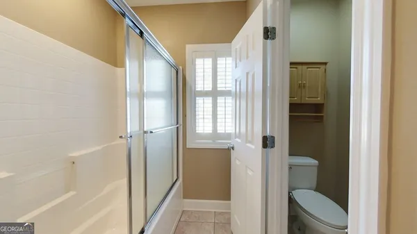a spacious bathroom with a double vanity sink a mirror and a shower