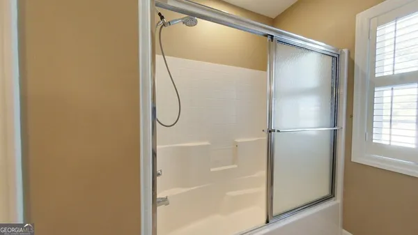 a bathroom with a shower and a shower