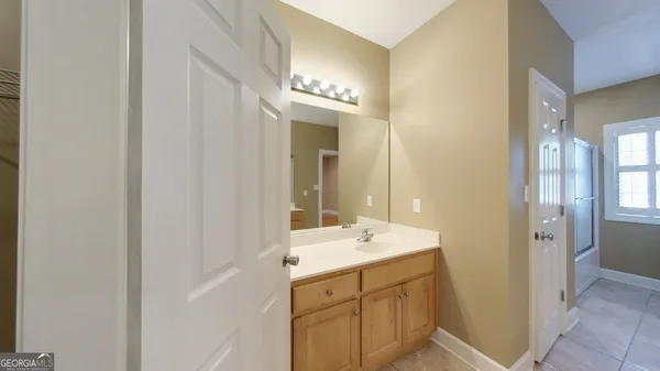 a bathroom with a double vanity sink and a mirror