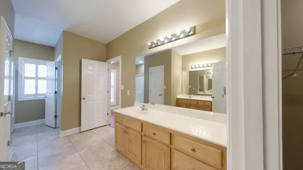 a bathroom with a double vanity sink and a mirror