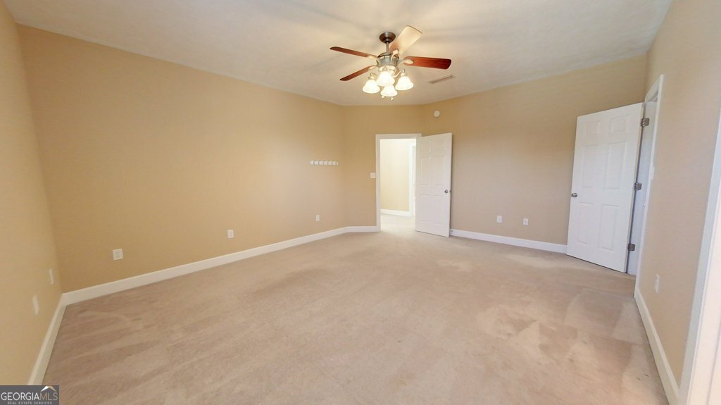 101 Willow Ridge Circle Thomasville, GA 31757 - Photo 52 of 92 an empty room with a chandelier fan and a window