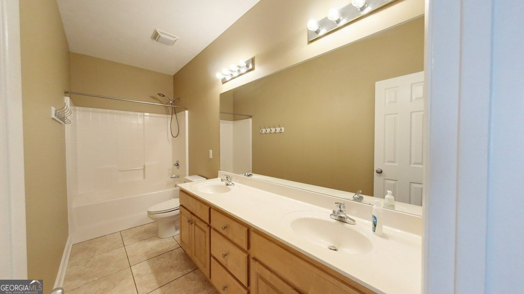 101 Willow Ridge Circle Thomasville, GA 31757 - Photo 59 of 92 a bathroom with a double vanity sink a large mirror and a shower