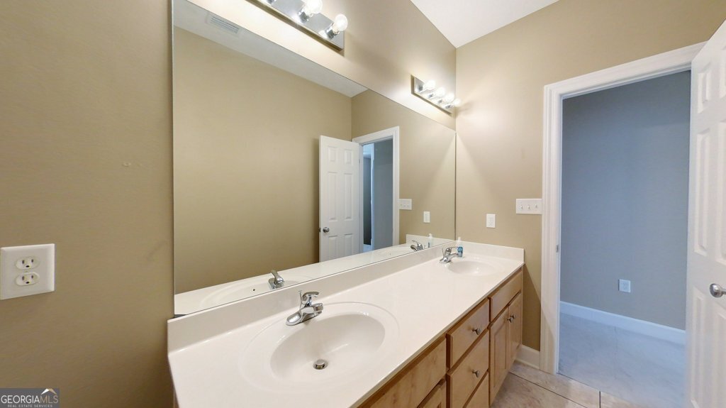 101 Willow Ridge Circle Thomasville, GA 31757 - Photo 60 of 92 a bathroom with a double vanity sink and a mirror